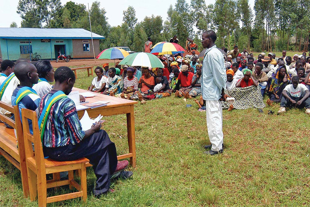 Image: A genocide suspect standing trial before a gacaca court in Zivu, Rwanda, March 10, 2005. Sourced from Britannica.com: https://www.britannica.com/topic/gacaca